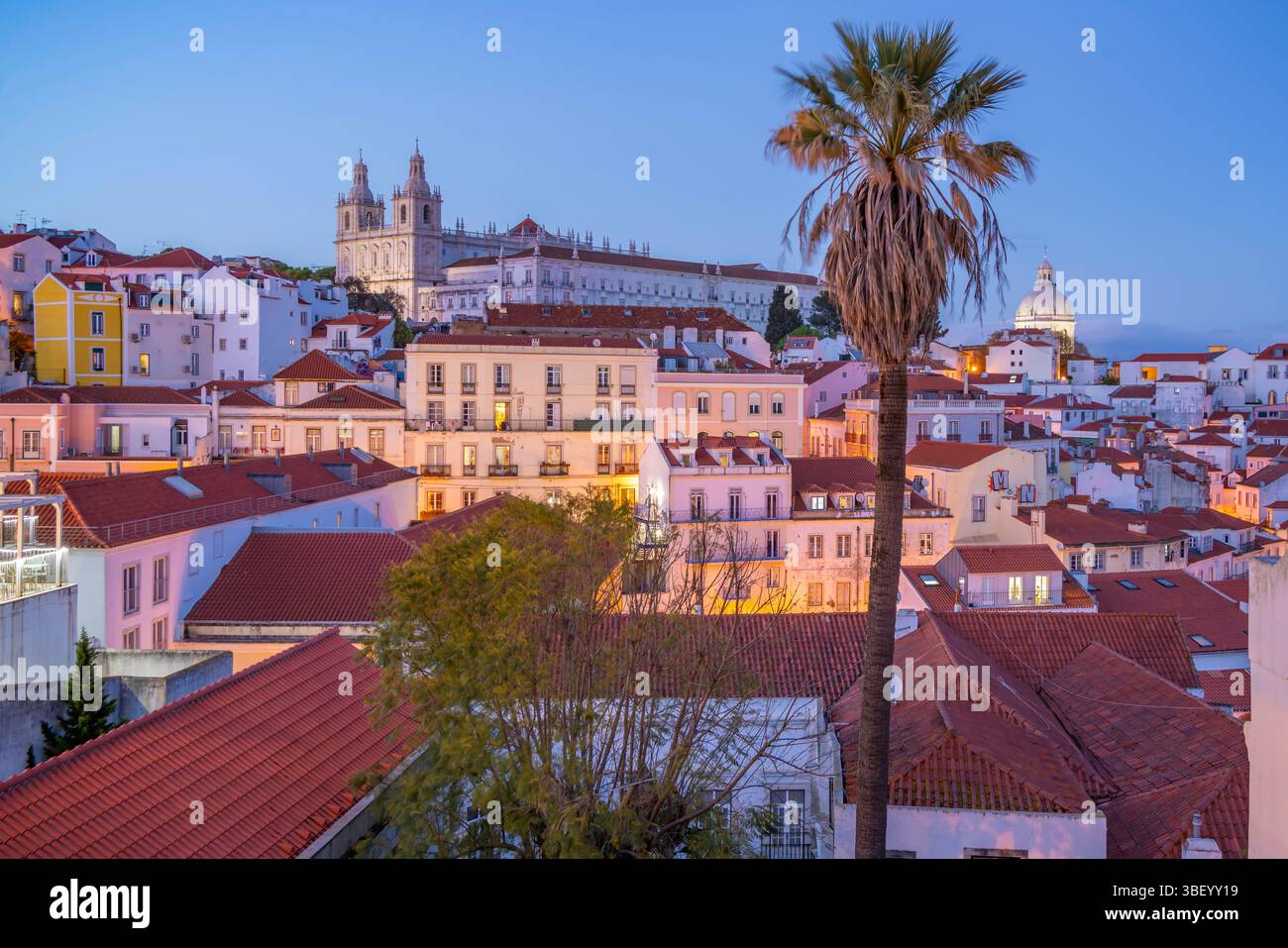 View of colourful buildings and red rooftops at dusk in the Alfama District, Lisbon, Portugal, Europe Stock Photo