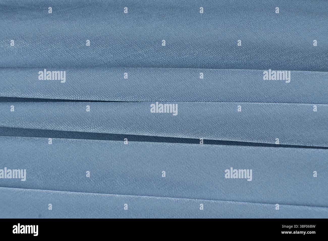 Soft Blue Fabric Background with Abstract Patterns and Empty Text Space. Stock Photo