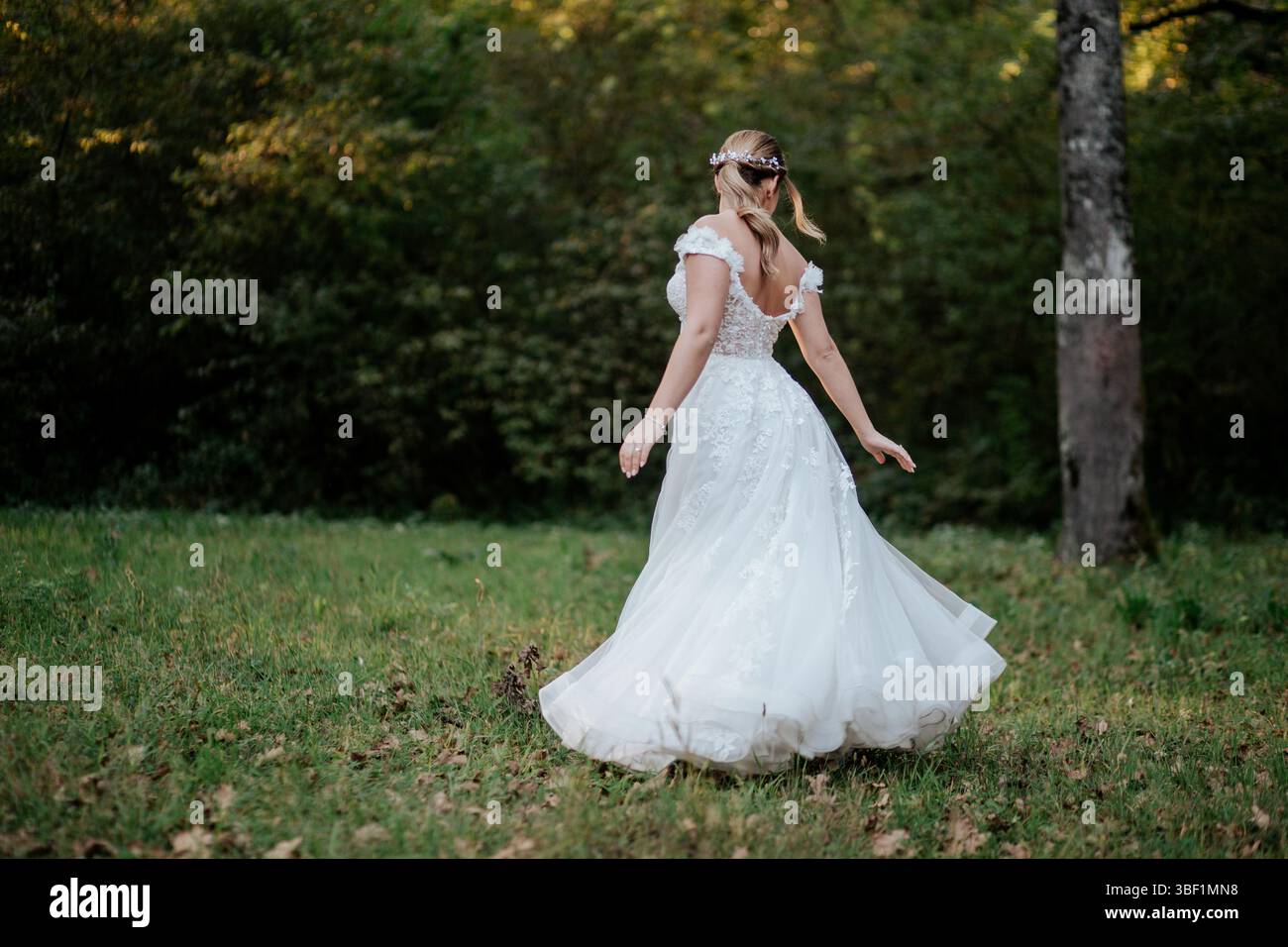 The image captures a bride in an elegant white wedding dress standing ...