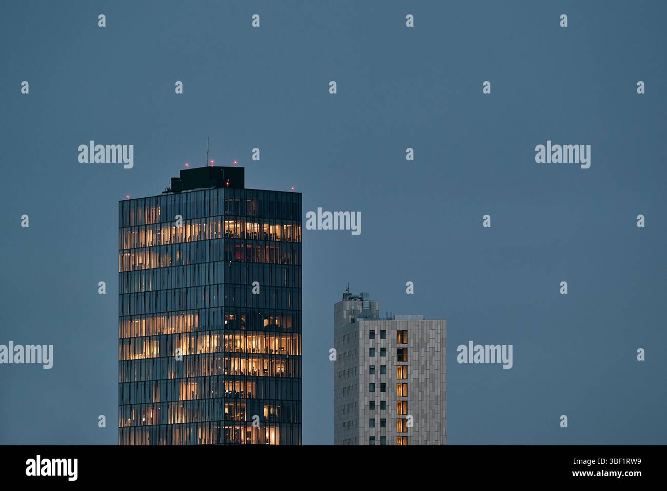 Modern skyscrapers lighting up the city skyline at dusk Stock Photo - Alamy