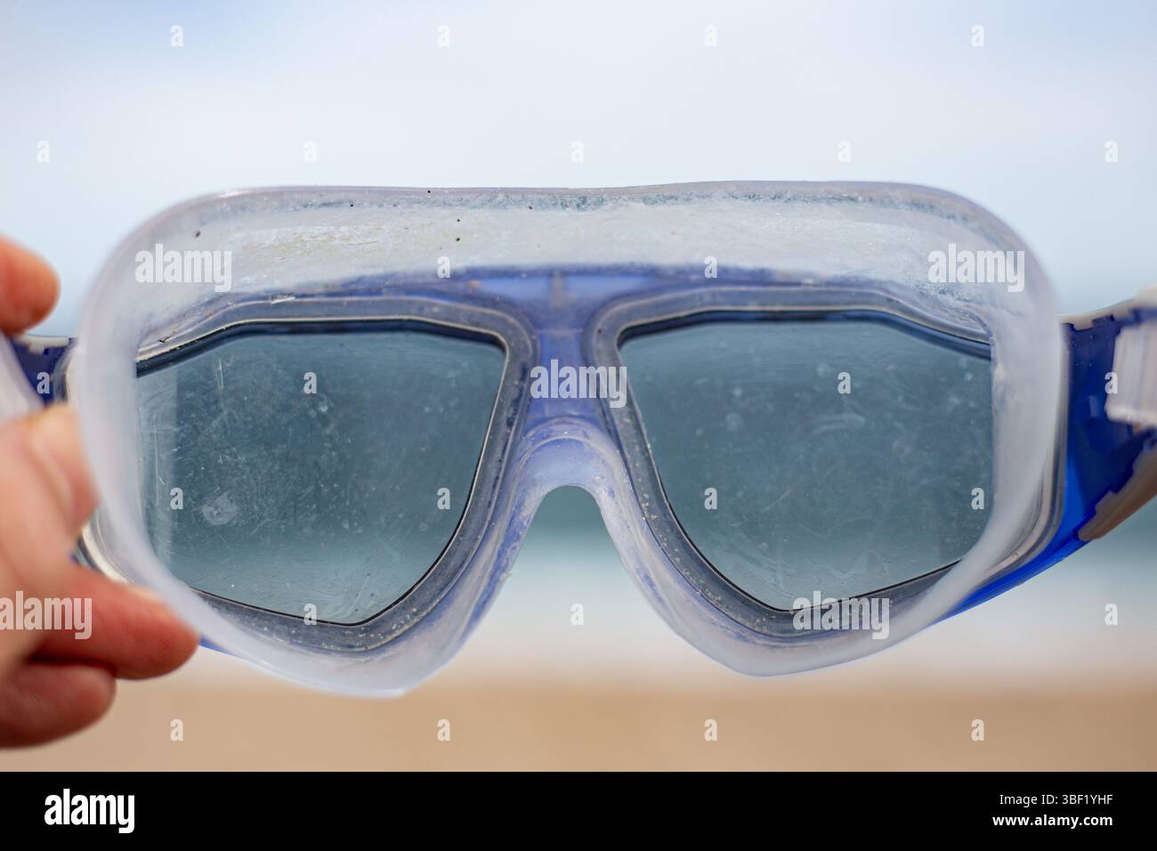 Snorkelling water lenses isolated on a brown and blue beacj background Stock Photo