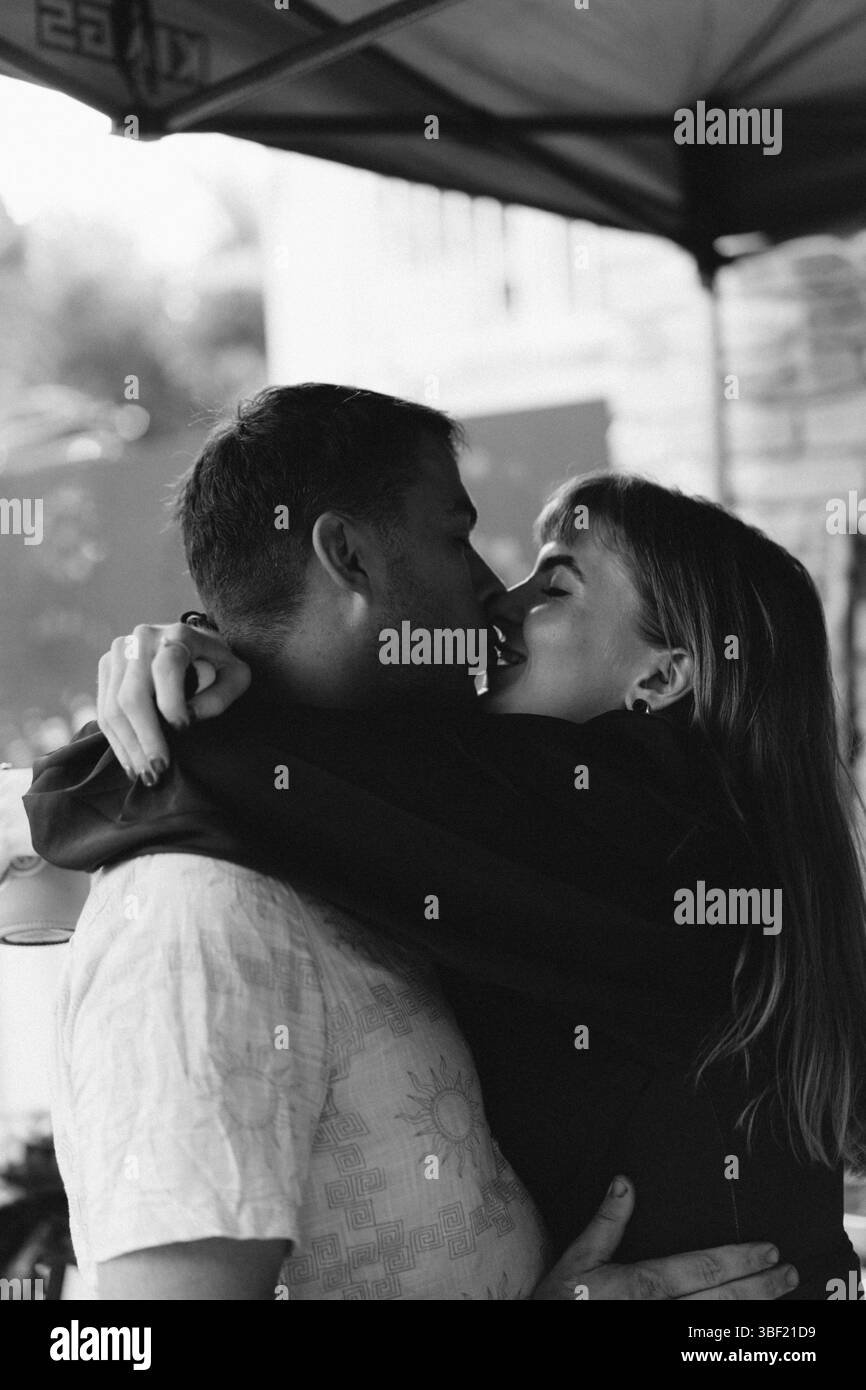 A couple sharing a tender kiss under the canopy Stock Photo