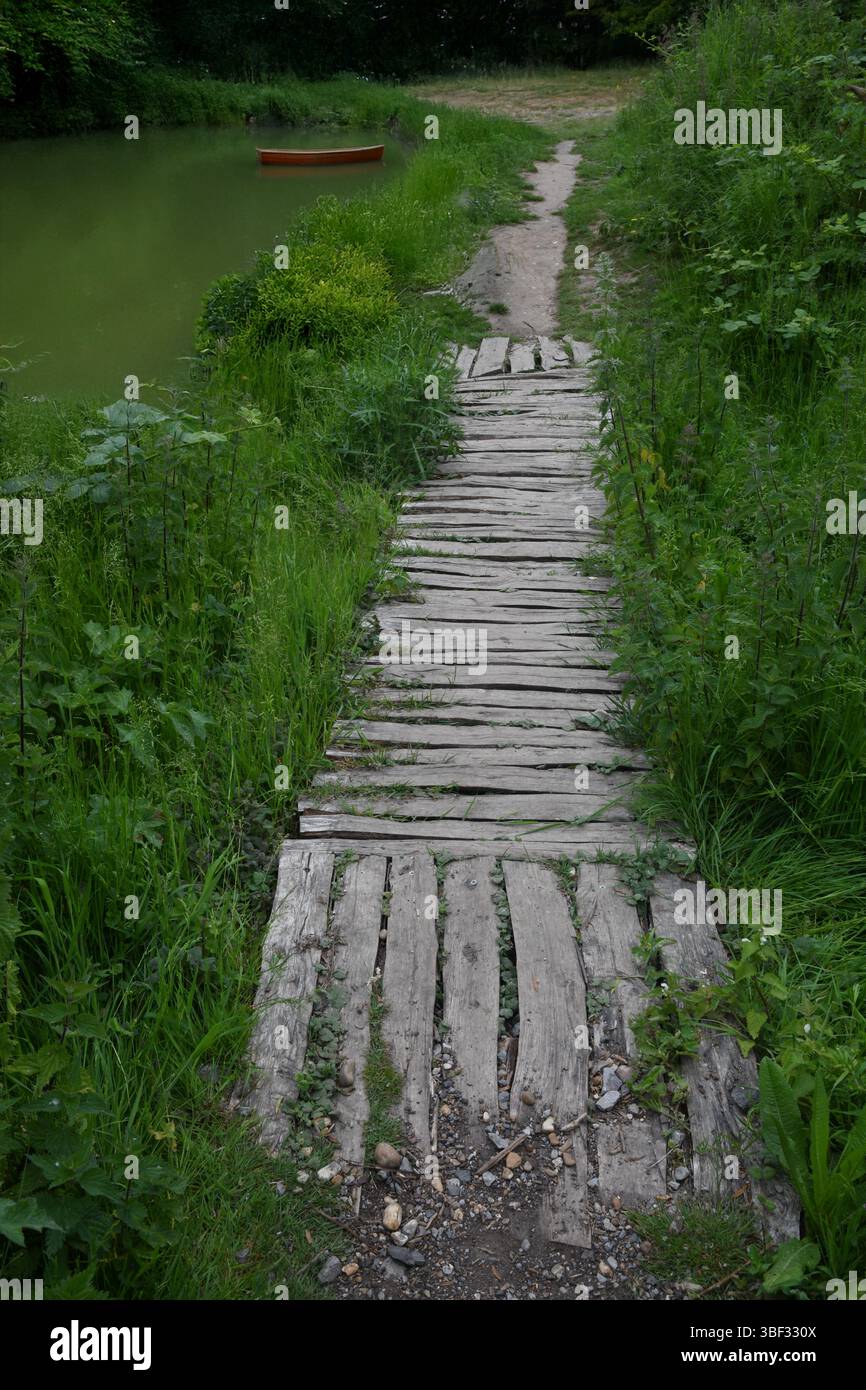 Wooden garden path and pond Stock Photo