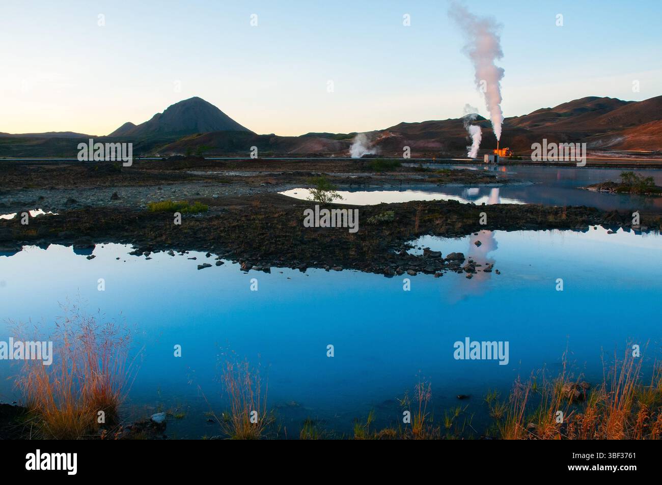 The Blue Lagoon’s vivid blue waters contrast beautifully with the surrounding lava fields, offering a unique geothermal spa experience. Stock Photo