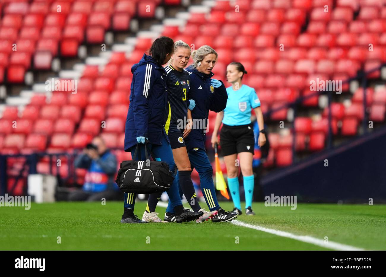 Scotland's Amy Muir leaes the pitch after picking up an injury during ...