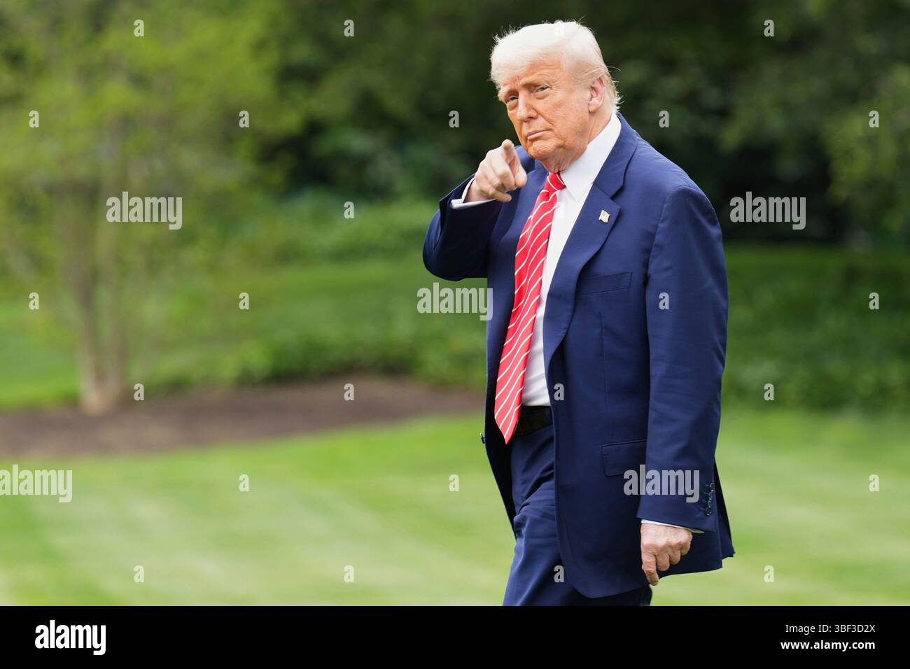 President Donald Trump walks on the South Lawn of the White House ...