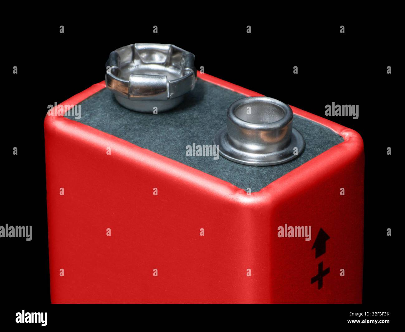 Close-up of a 9V battery displaying the positive terminal indicator on ...