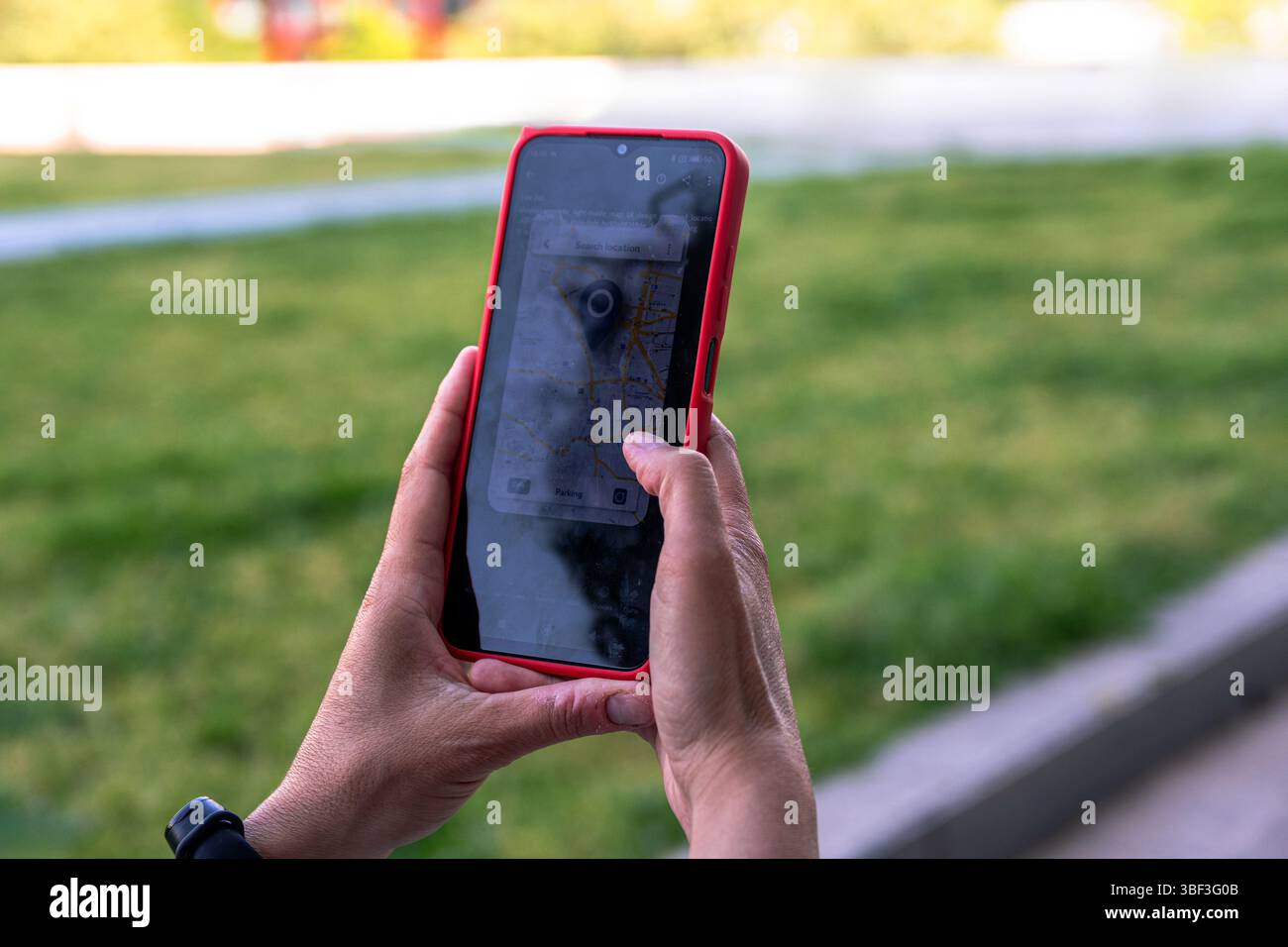 Woman using navigation app on smartphone in park Stock Photo