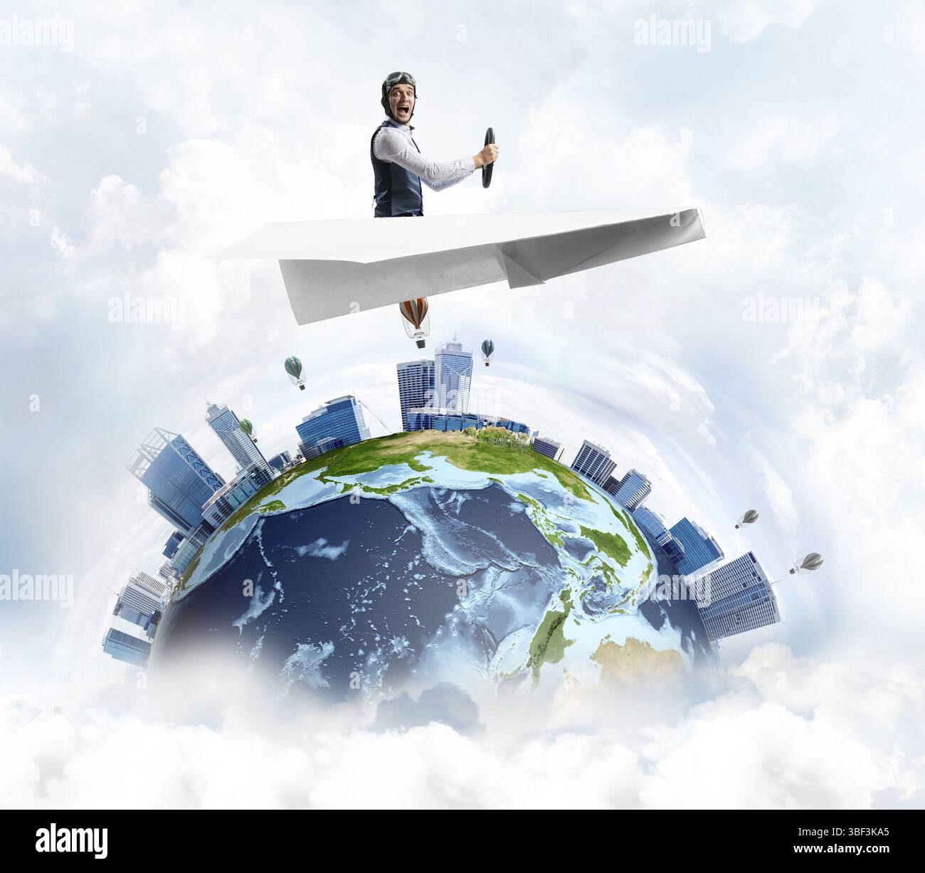 Pilot in leather helmet and goggles driving paper plane in cloudy blue ...