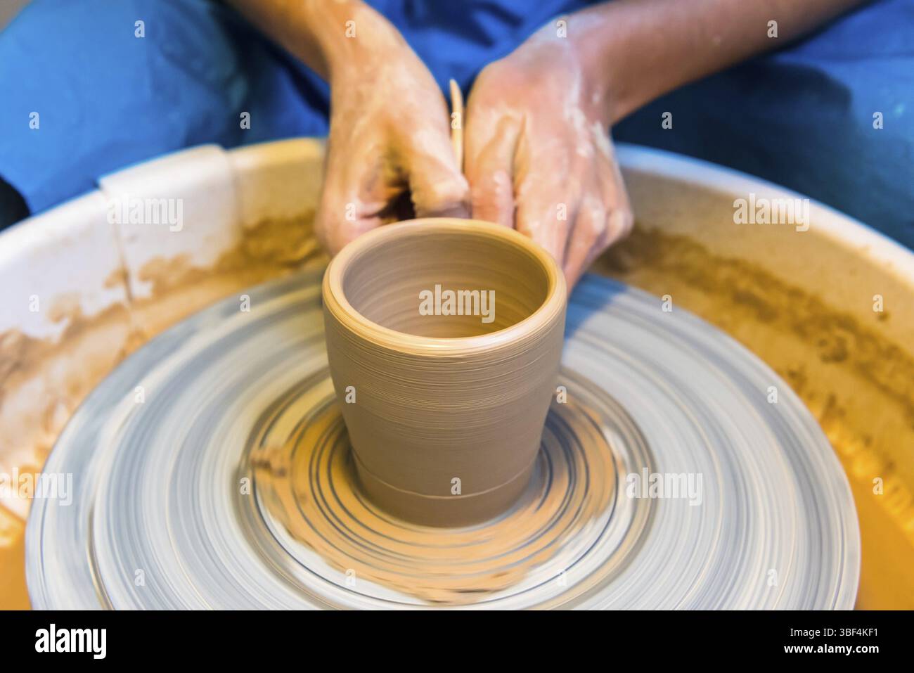 Pottering - creating a clay cup in process. Shot with a small GRIP Stock Photo