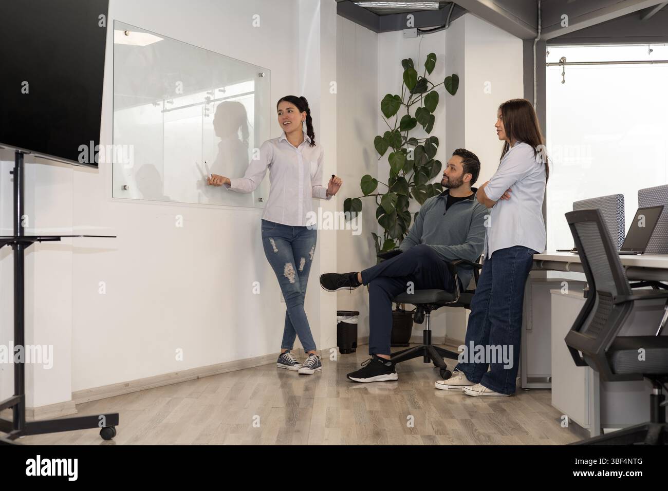 Three Professionals Collaborating Three colleagues gather in hi-res stock photography and images - Alamy