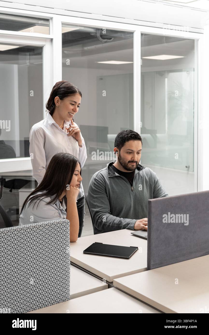Front view of coworkers listening as their manager explains how to ...