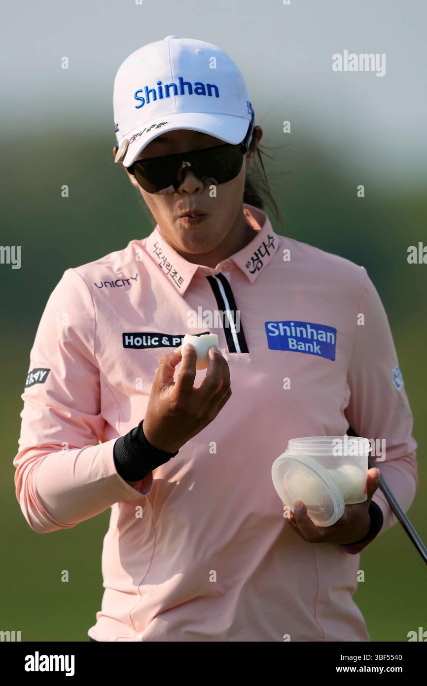 Jin Hee Im, of South Korea, eats an egg on the fifth hole during the ...