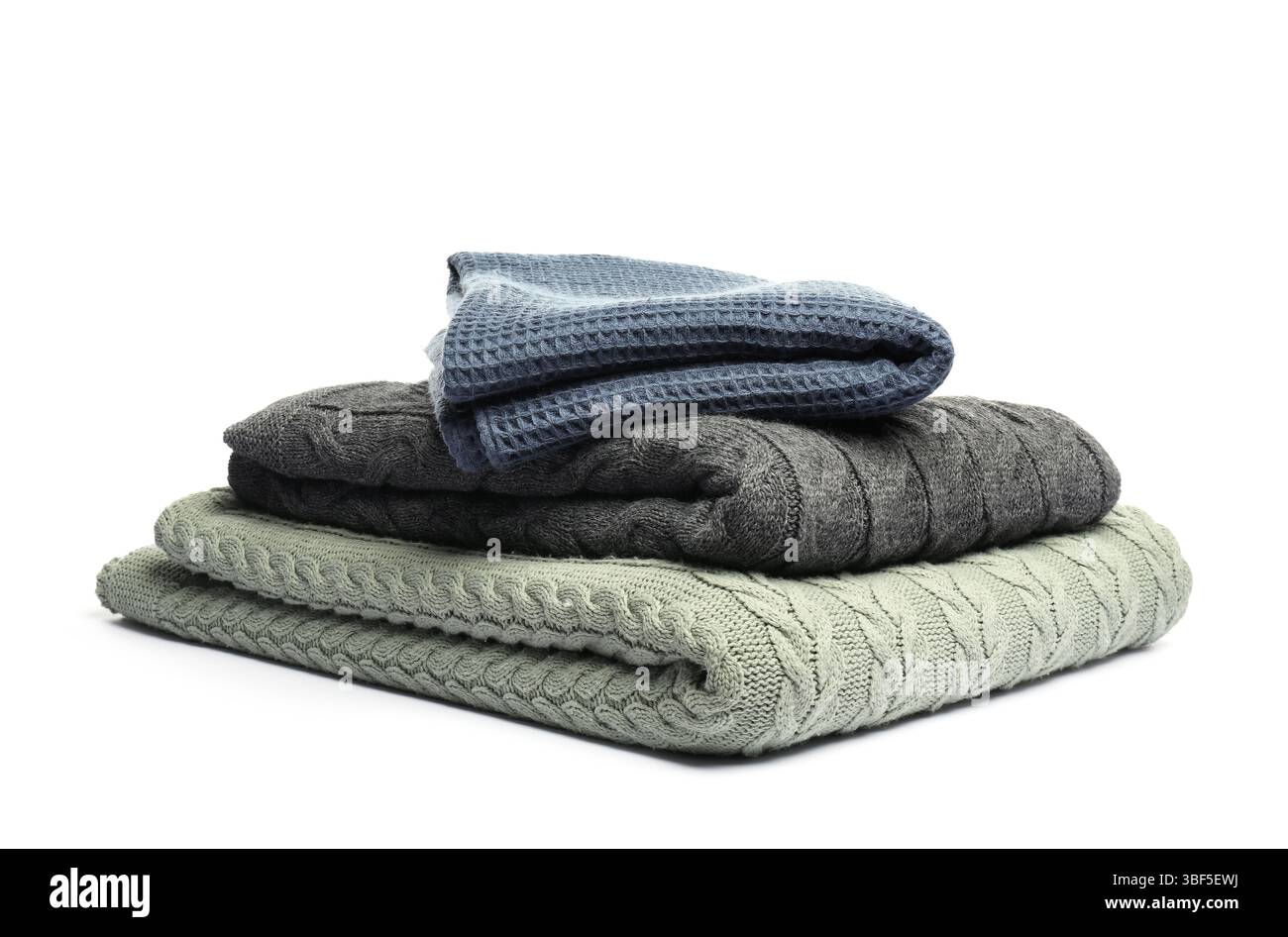 Stack of folded blankets isolated on white Stock Photo
