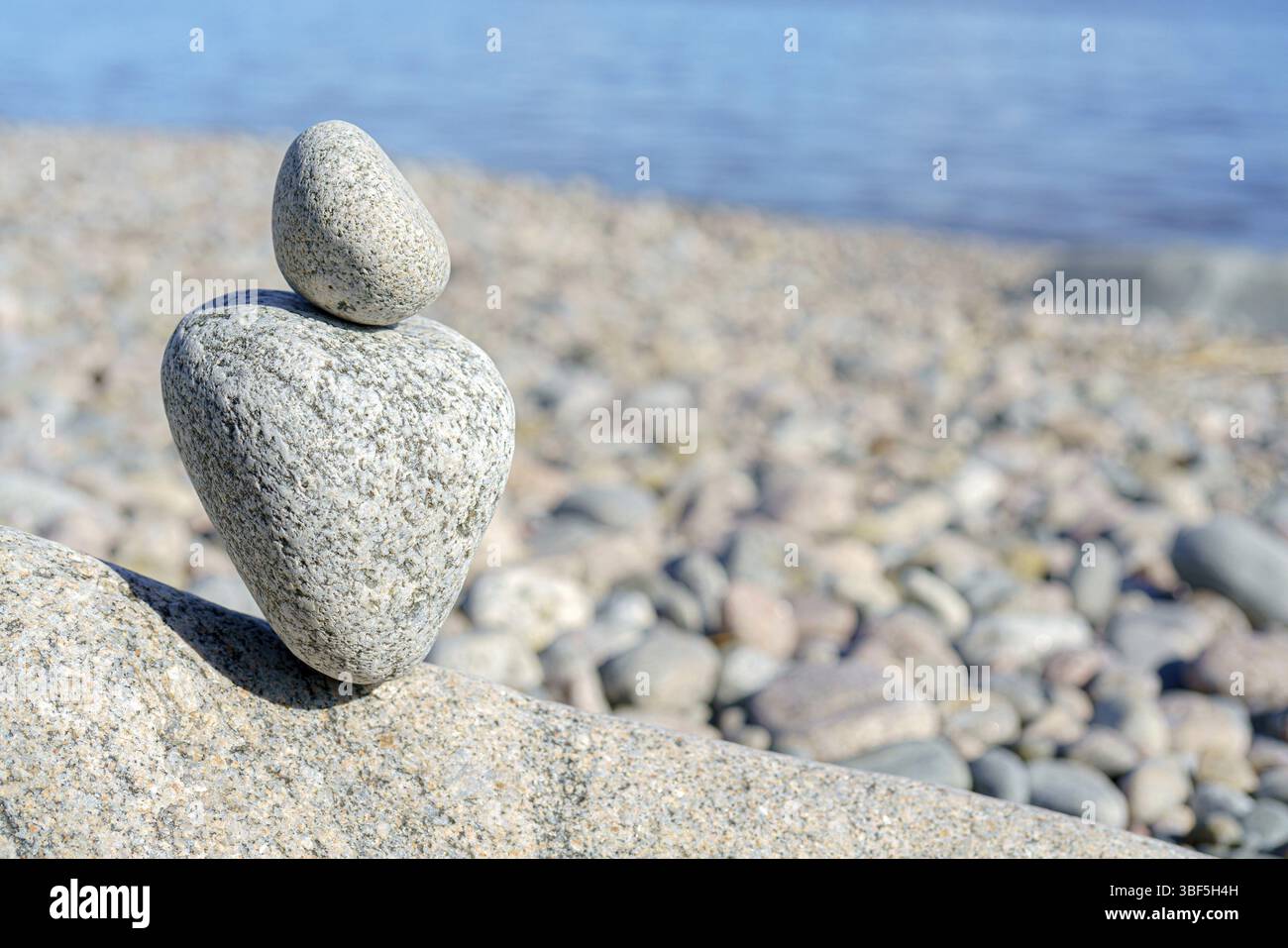 Stacked Rocks balancing, stacking with precision. Stone tower on the shore. Copy space Stock Photo