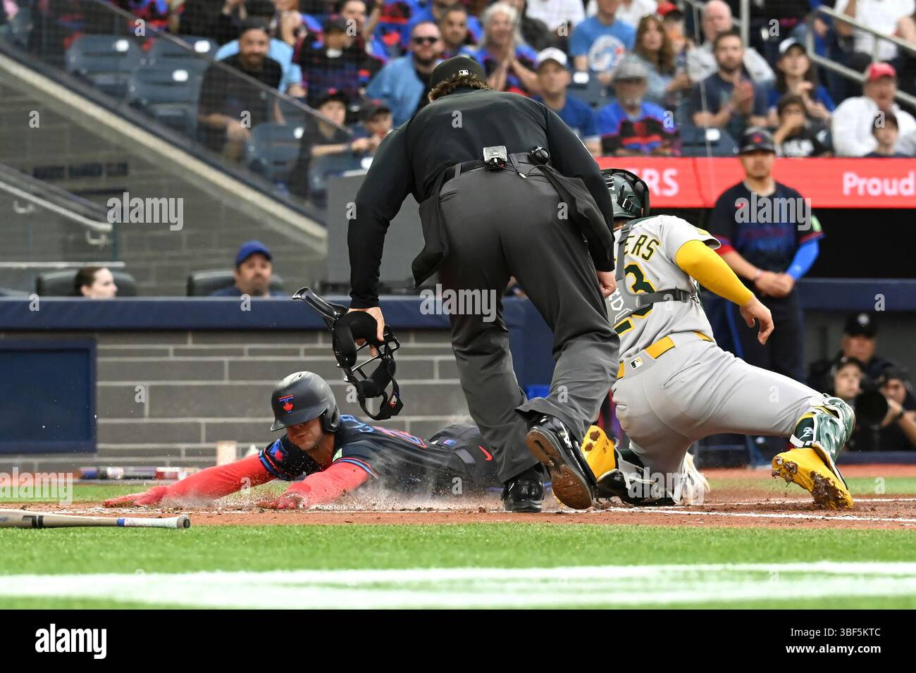 Toronto Blue Jays' Ernie Clement (22) slides safely into home ahead of ...