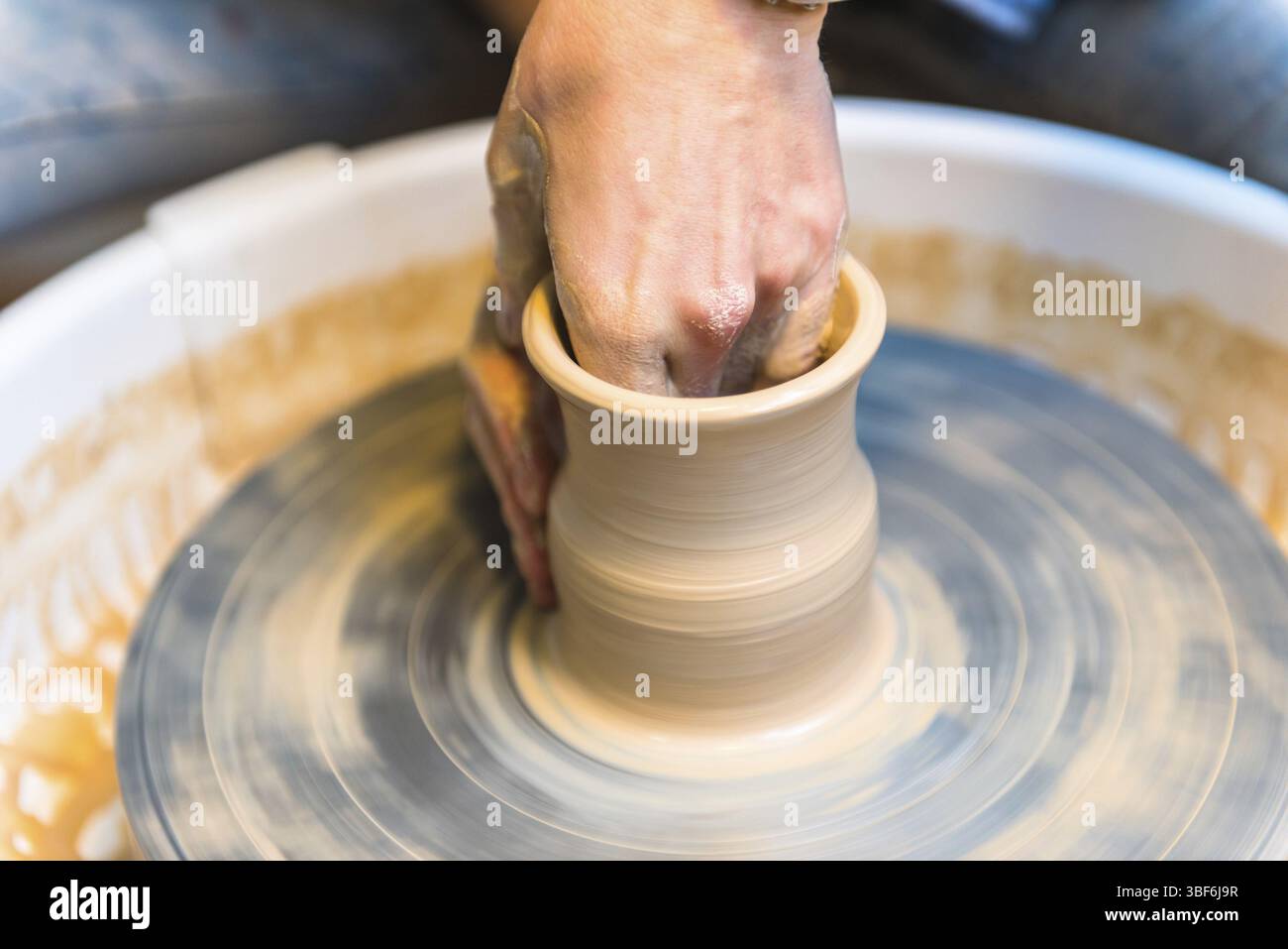 Pottering - creating a clay cup in process. Shot with a small GRIP Stock Photo