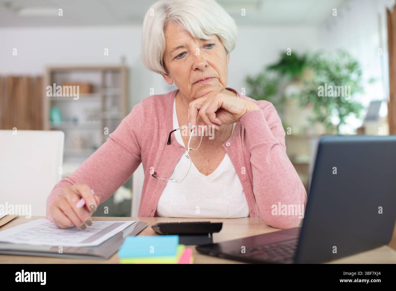 beautiful senior woman working with documents and laptop Stock Photo ...