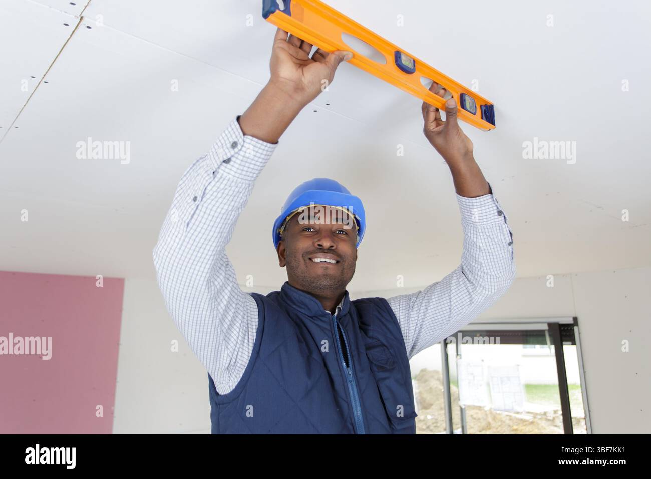 taking measures with spirit level on the ceiling Stock Photo