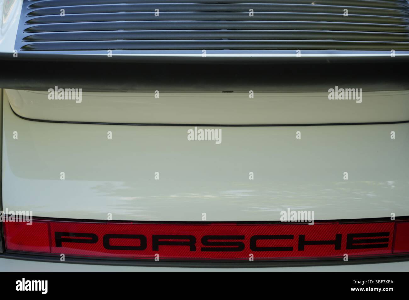 White Porsche Rear. A white Porsche shows its striking rear view with a ...