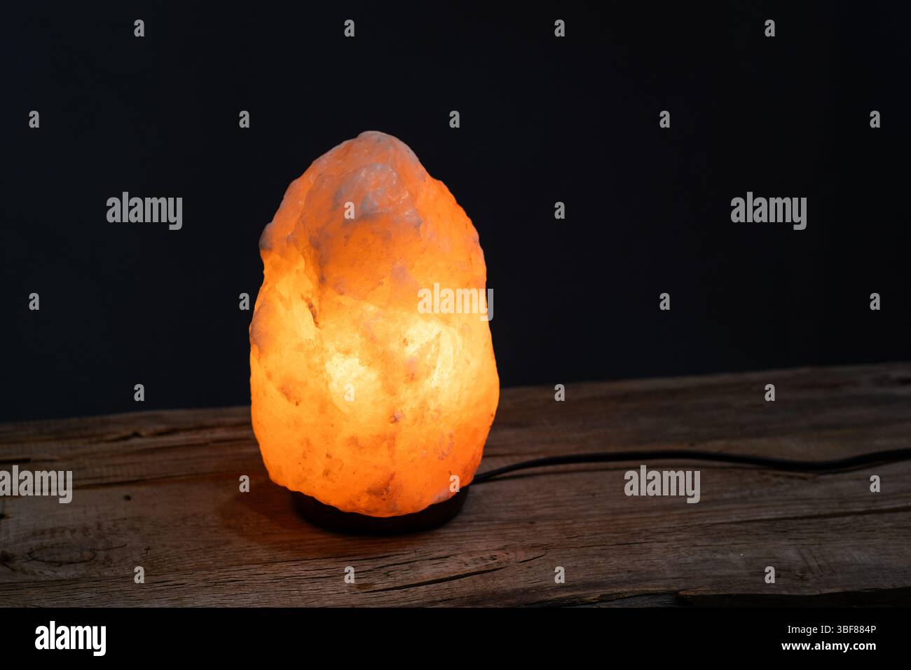 Himalayan salt lamp on black background Stock Photo
