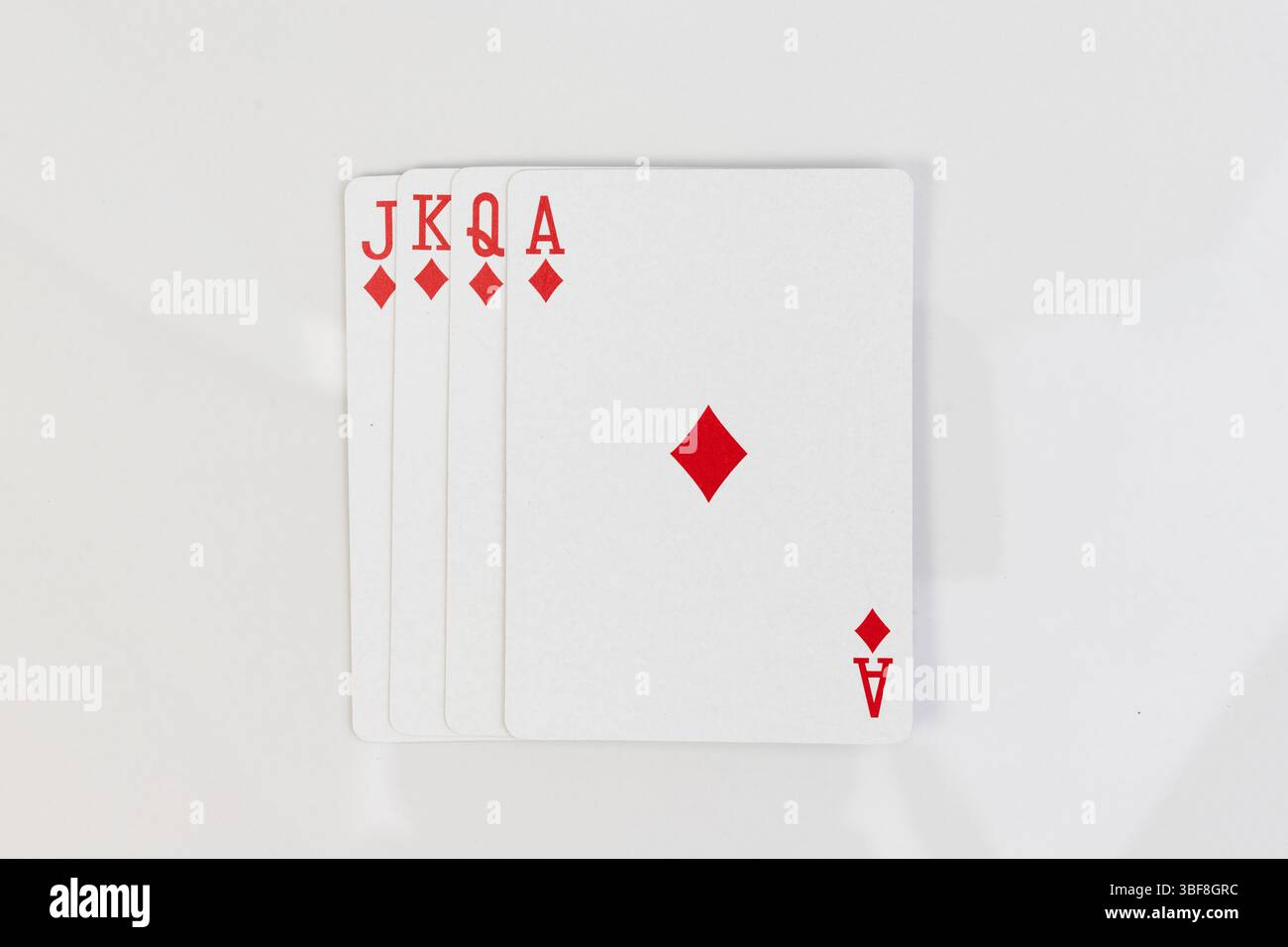 Royal flush in diamonds. Playing cards spread on white isolated background with copy space Stock Photo