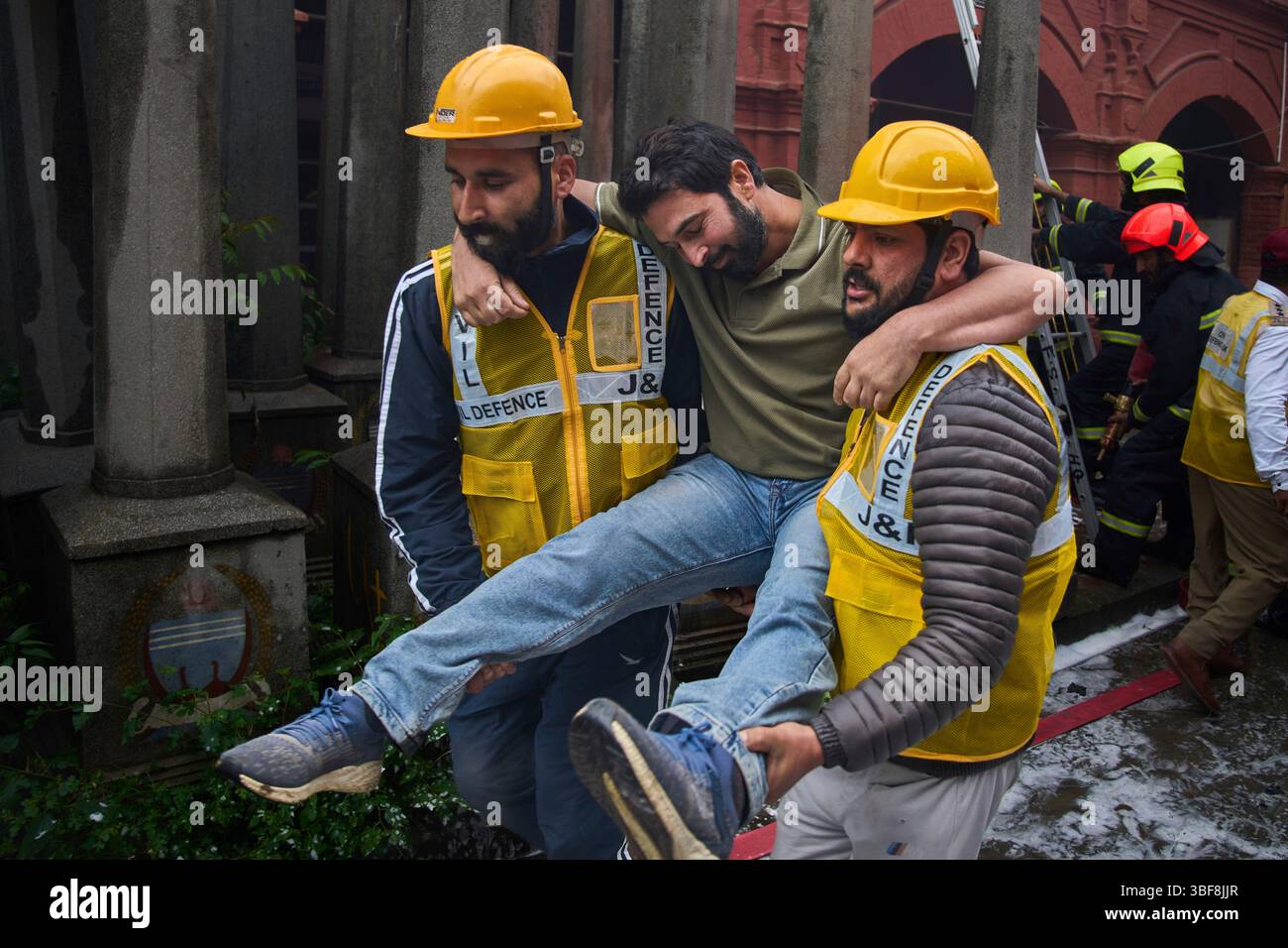 Civil defense members carry out a mock drill to train civilians and ...