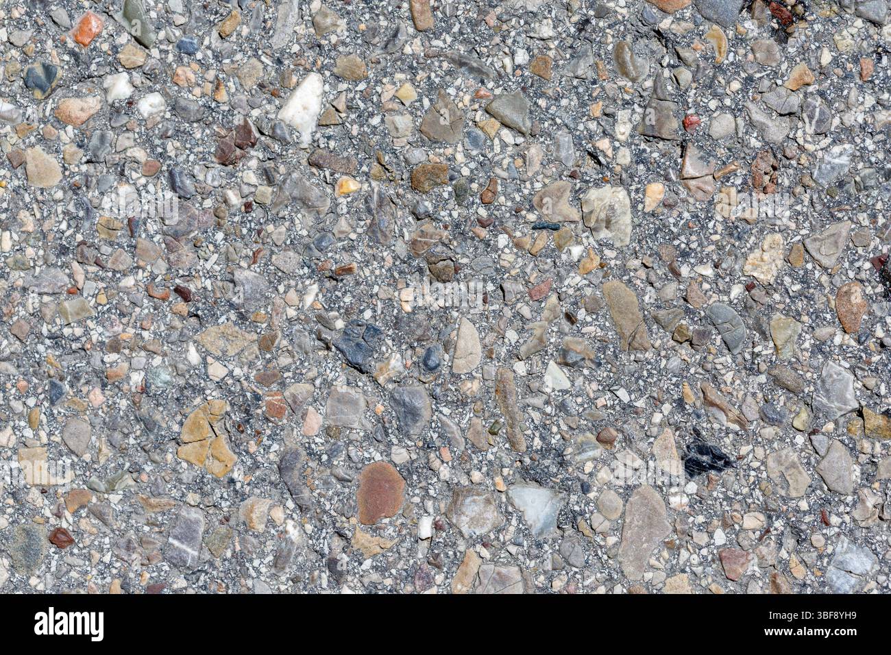 Small Bumpy Rocks Gray Close-up of a gray surface embedded with various small rocks and ...