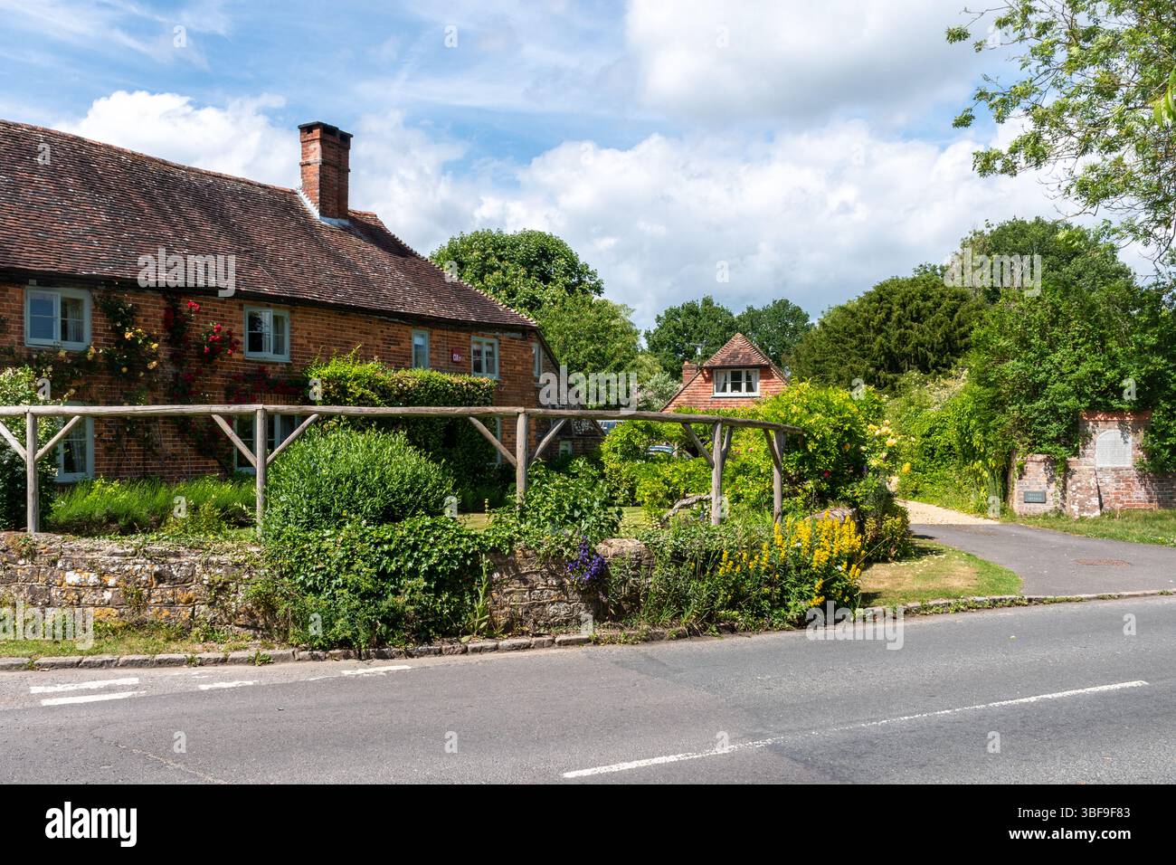 View of attractive properties and gardens in Kirdford, a pretty village in West Sussex, England, UK, during May. Stock Photo