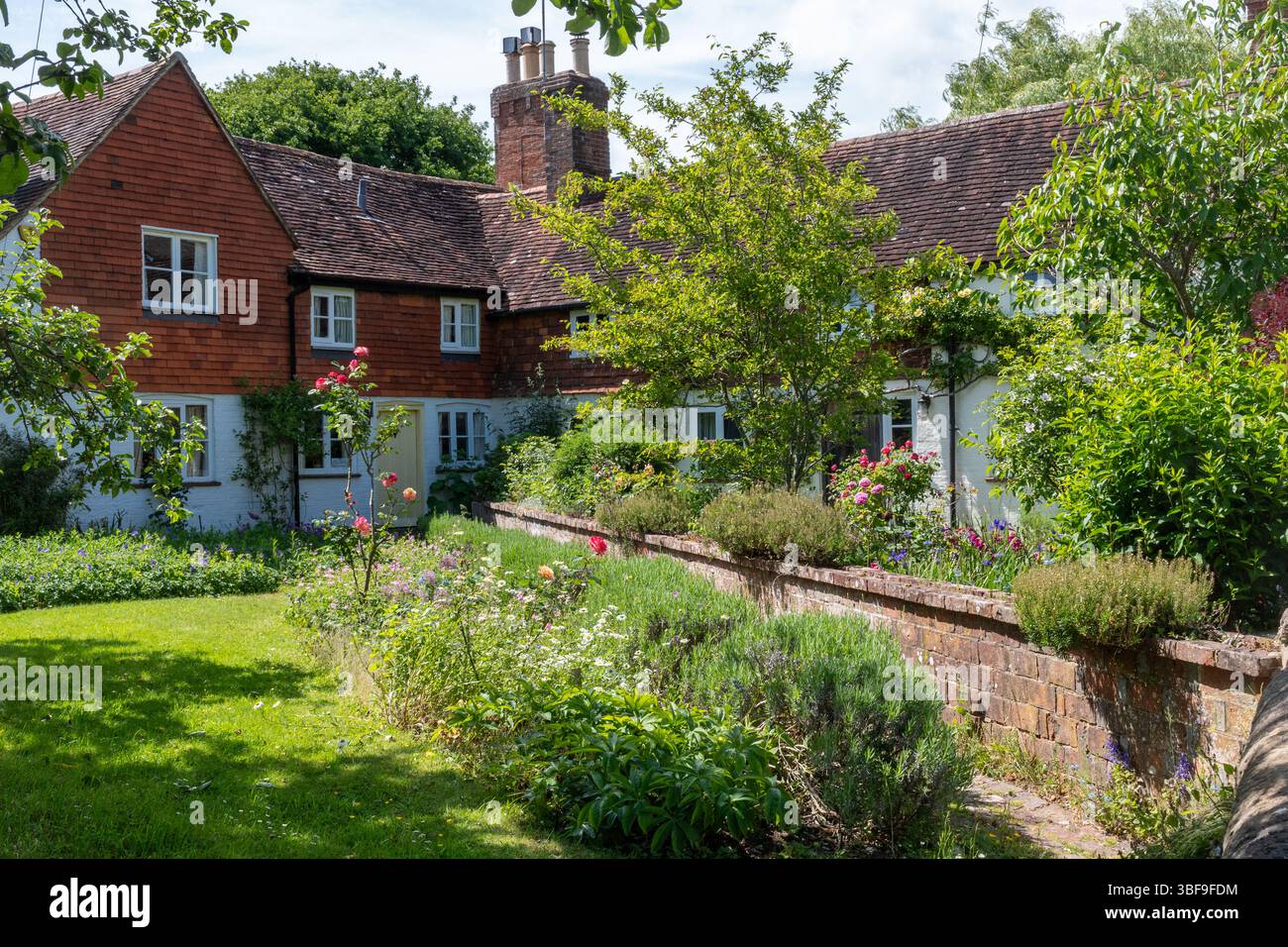 View of attractive properties and gardens in Kirdford, a pretty village in West Sussex, England, UK, during May. Stock Photo