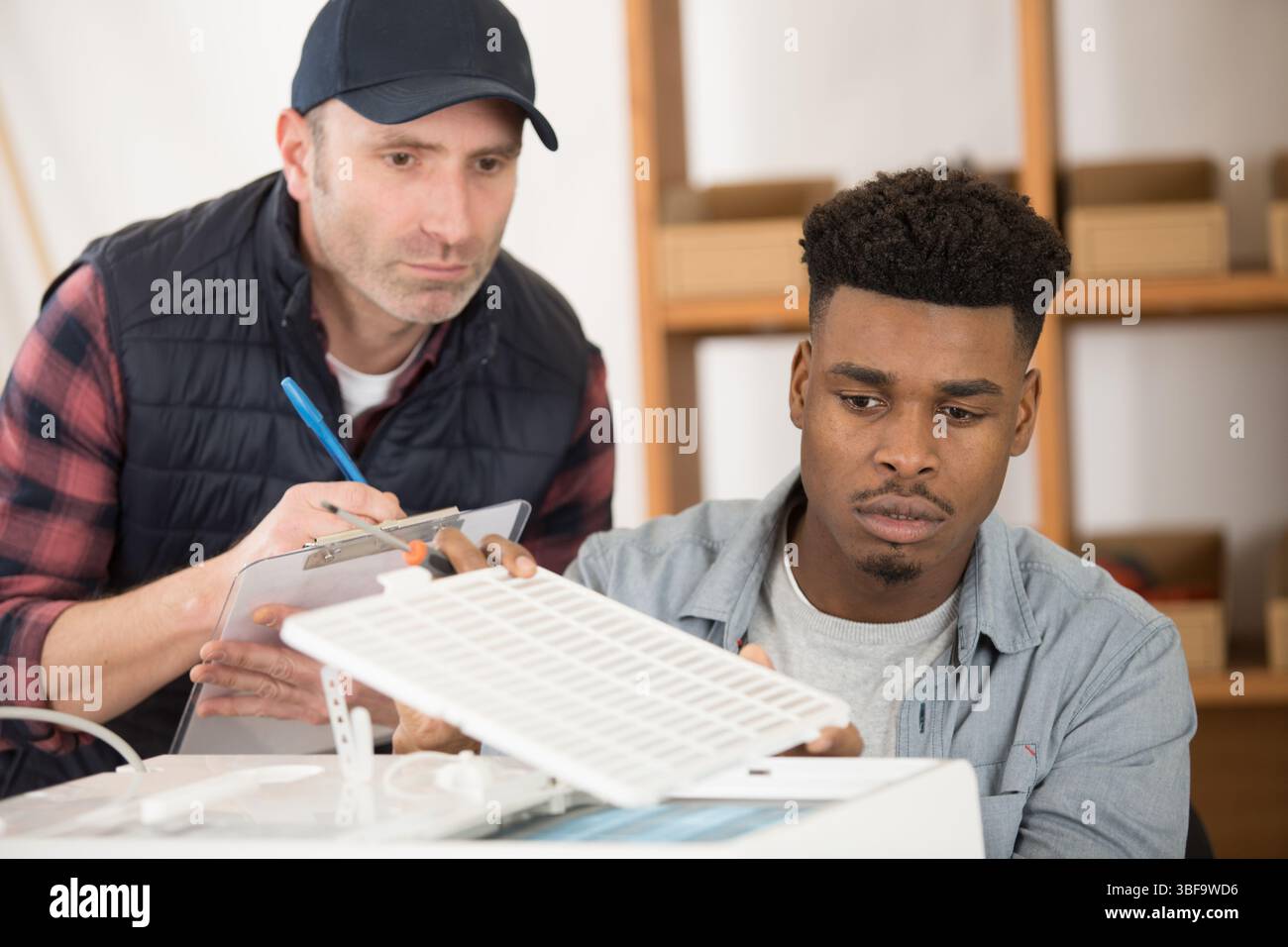 men working tpgether on printer Stock Photo