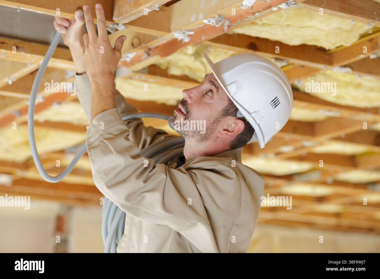 male builder working with cables Stock Photo