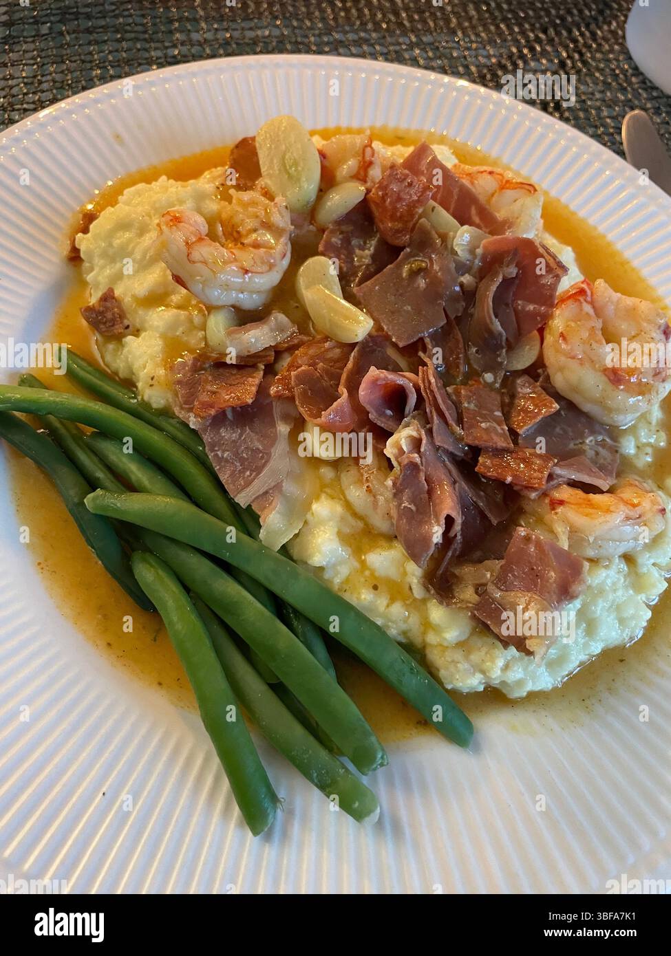 Shrimp and grits served on a White Plate, USA, 2025 - Smartphone Captured Stock Image