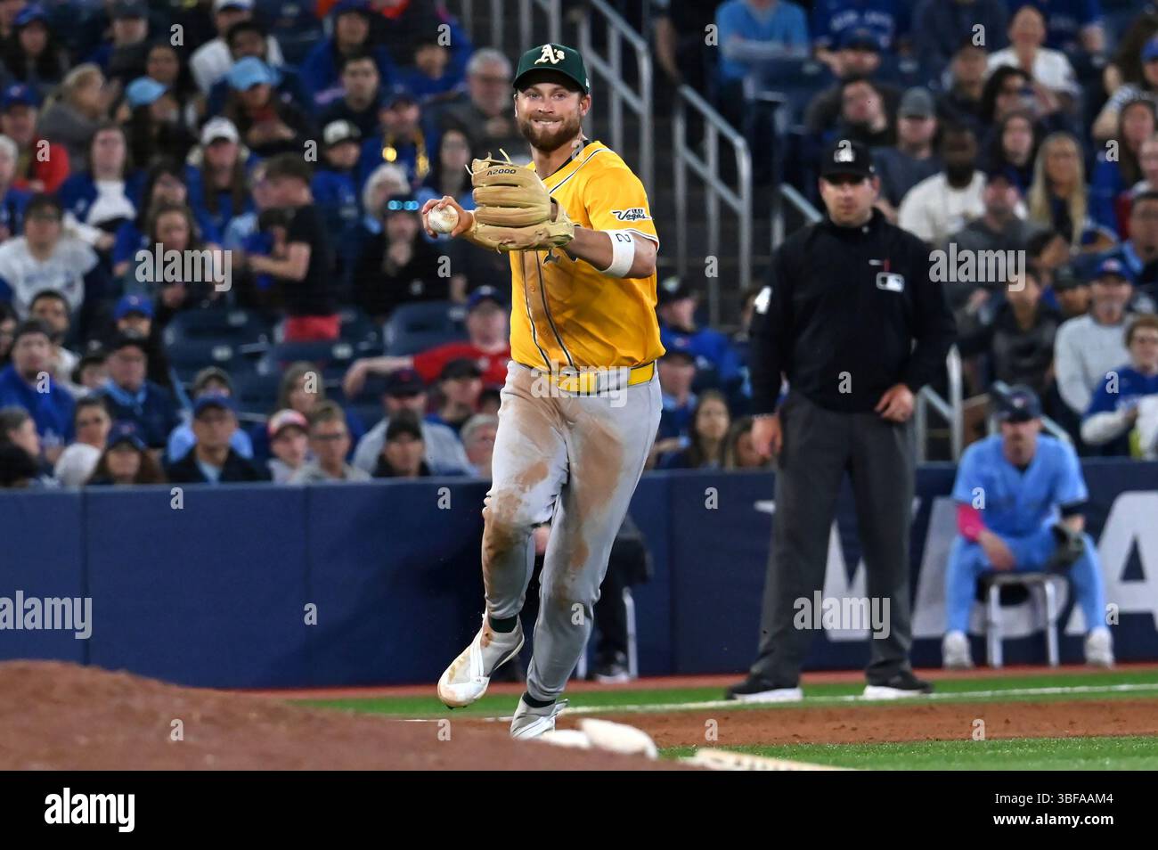 Athletics third baseman Max Schuemann (12) throws to first base to put ...
