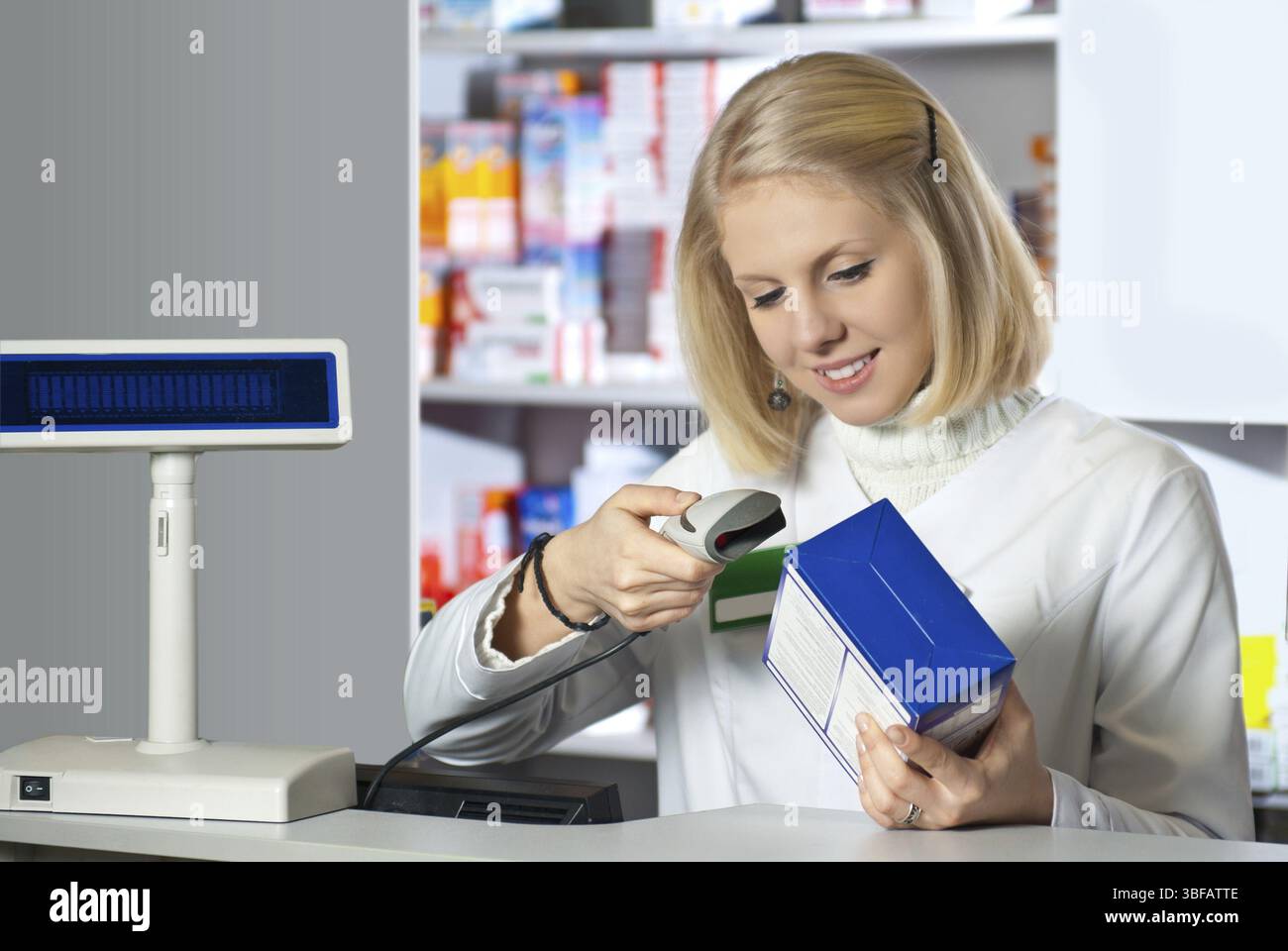 Pharmacist scanning medicine with barcode reader Stock Photo