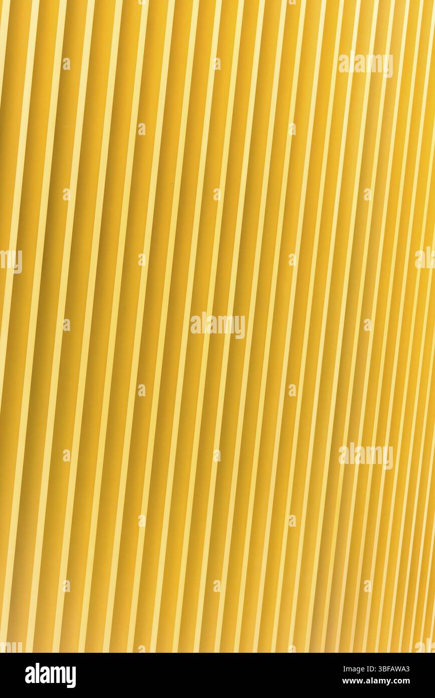 Detail of bright yellow metal building facade. For background Stock ...