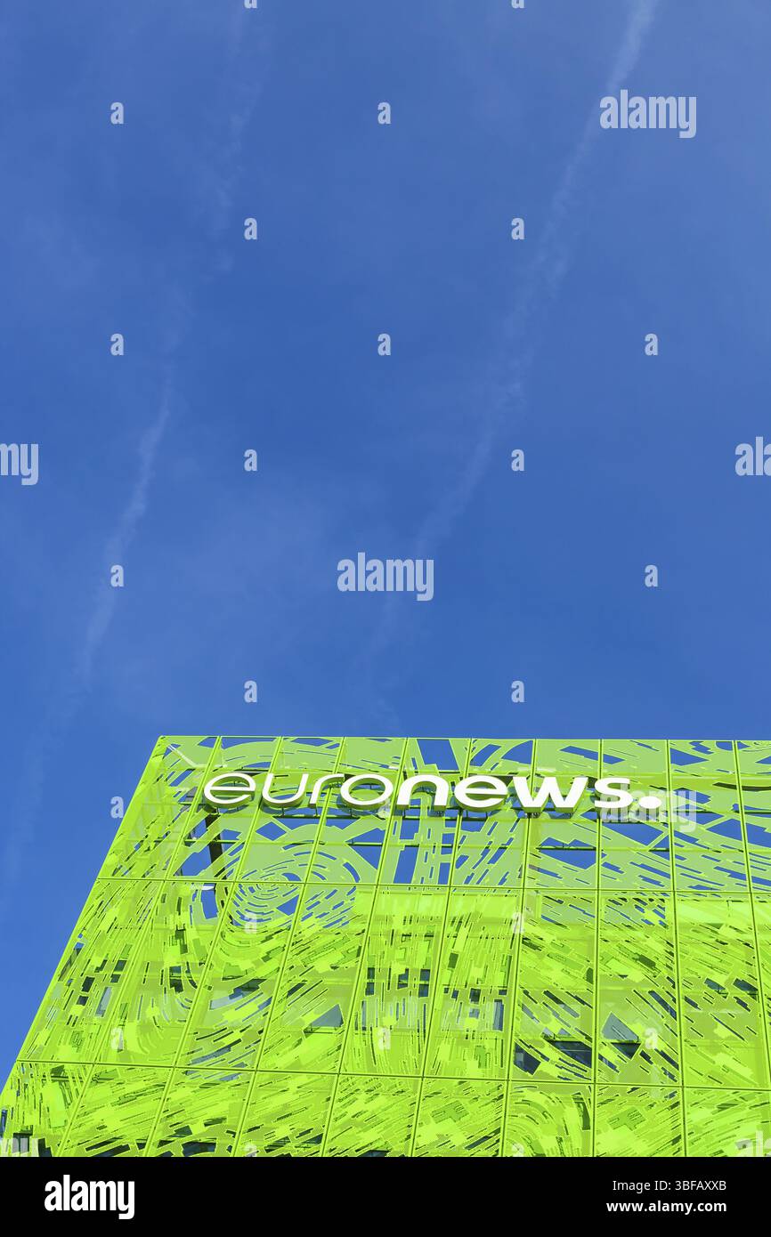 Euronews, european pay television news network brand logo on its headquarter office building located in eco-district Confluence. Blue sky background w Stock Photo