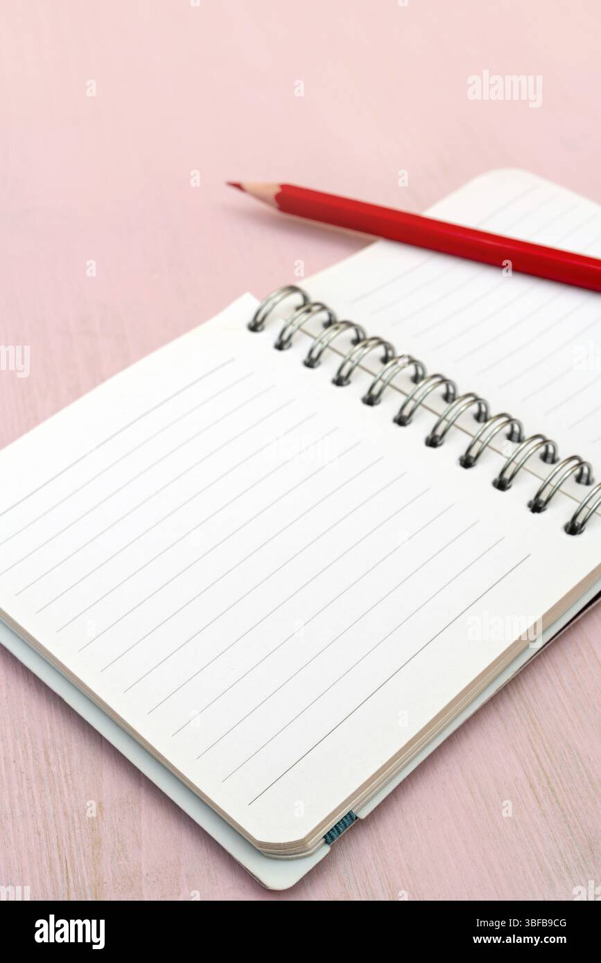 Red pencil and notebook for notes Stock Photo