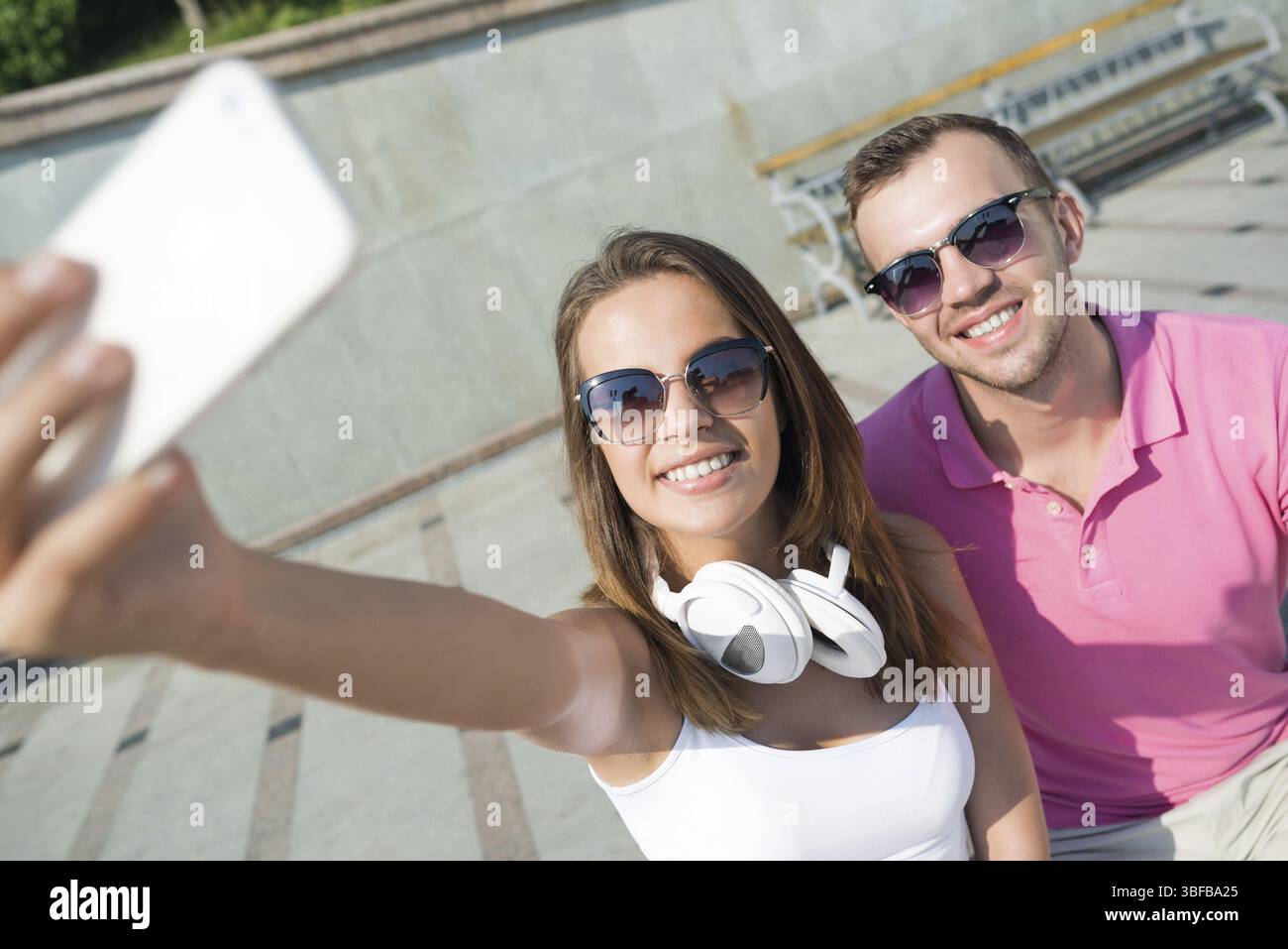 Young smiling couple in summer street taking selfie portrait Stock Photo