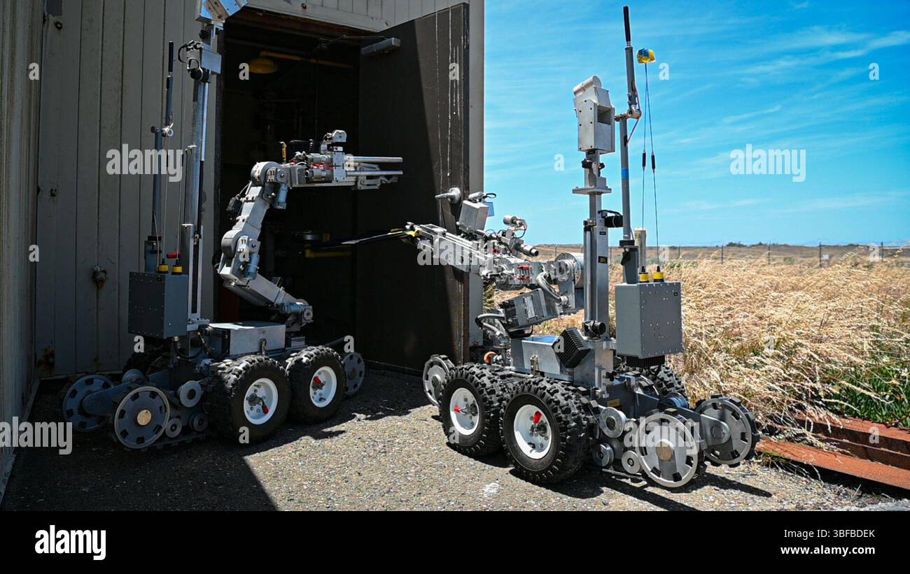 Explosive Remote System Two unmanned F6A Remote Ordnance Neutralization System robots pry-open ...