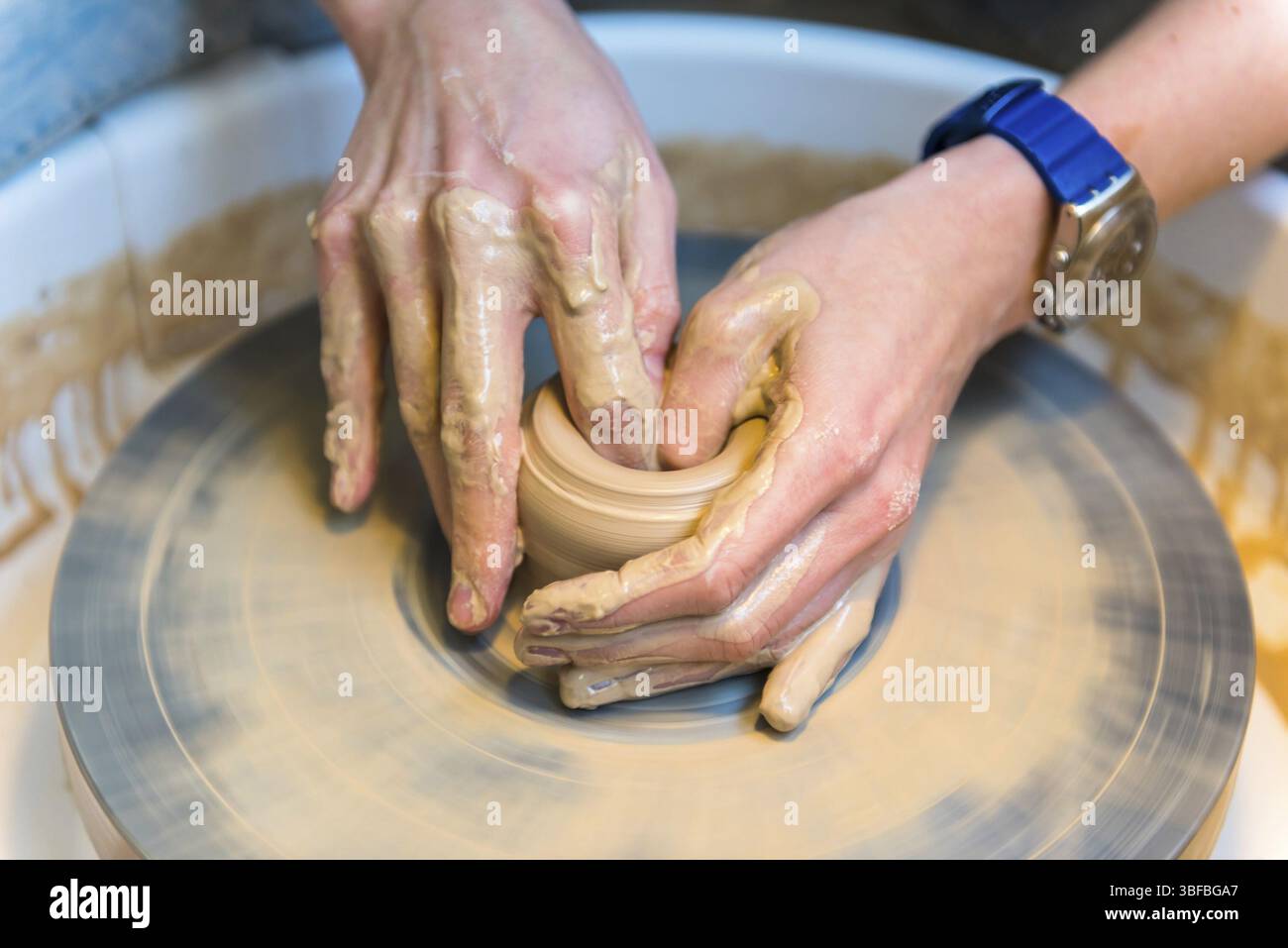 Pottering - creating a clay cup in process. Shot with a small GRIP Stock Photo