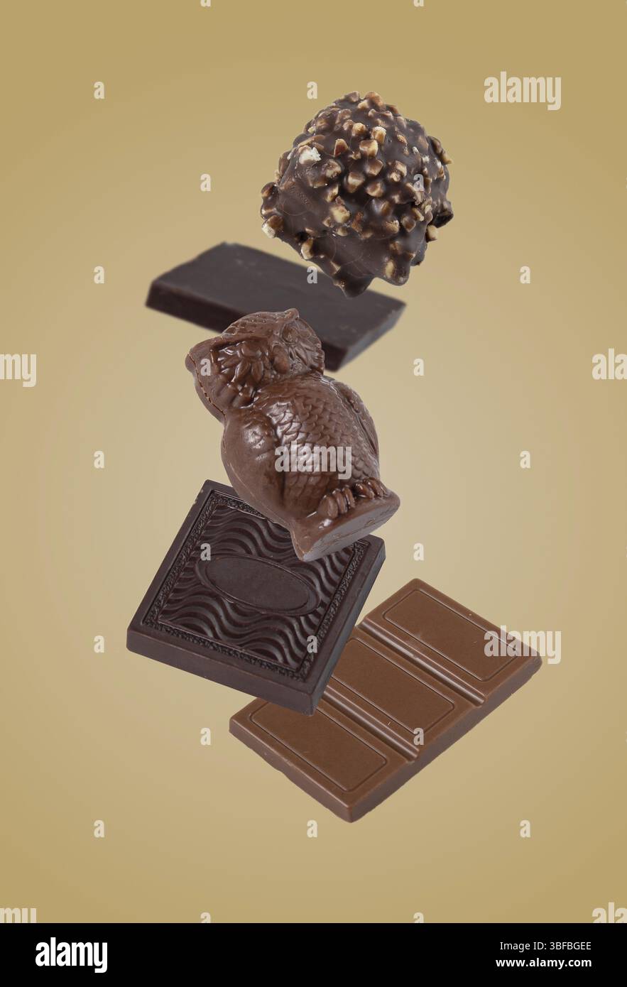 Chocolate candies flying on a yellow background Stock Photo