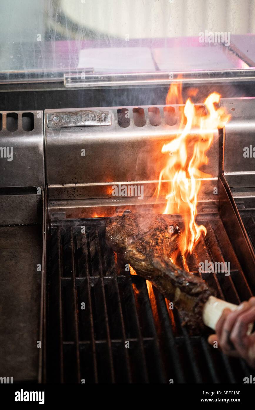 Tomahawk steak on fire in restaurant Stock Photo