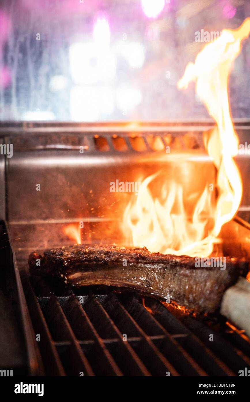 Tomahawk steak on fire in restaurant Stock Photo