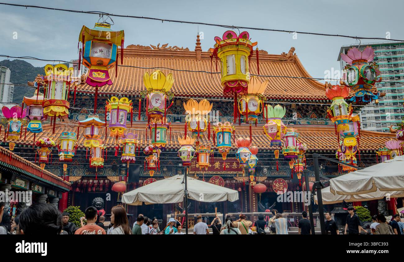 Wong Tai Sin Temple building and hanging lanterns located in Hong Kong City. Photo taken on a cloudy day Stock Photo