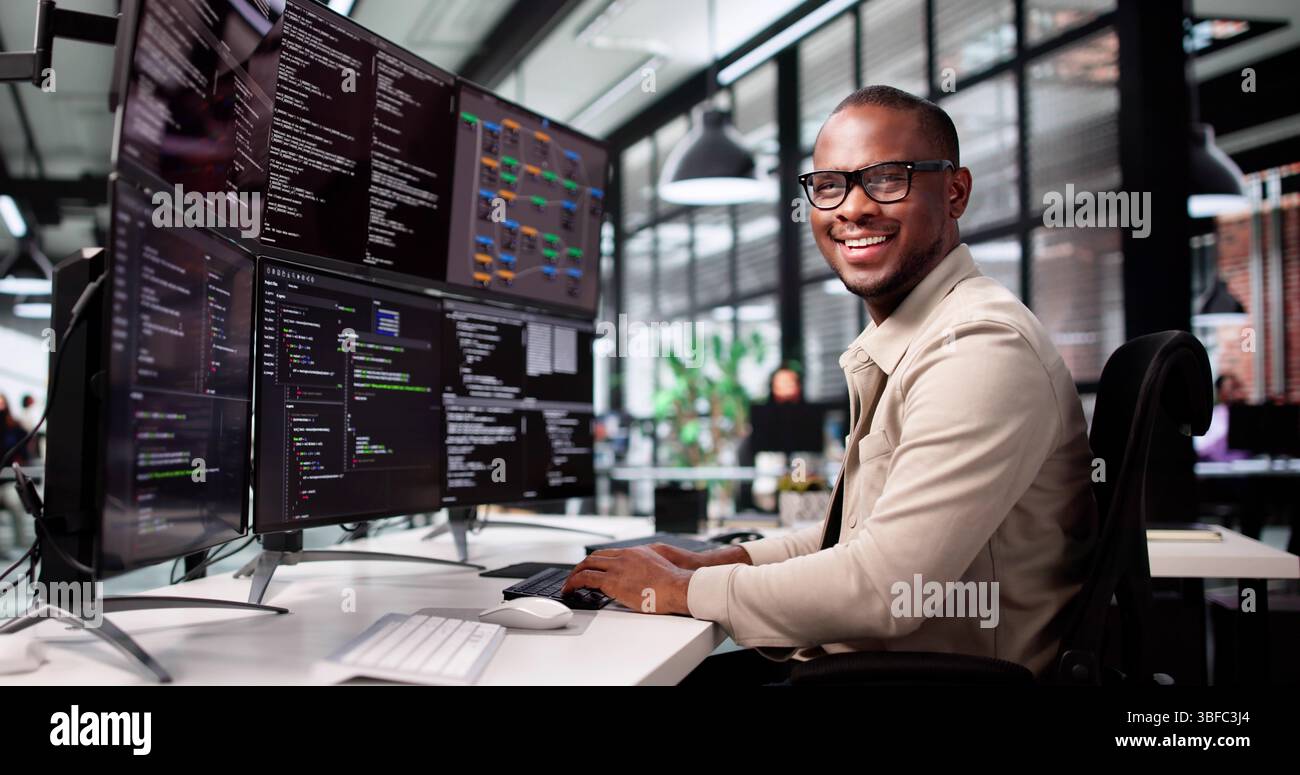 Smiling African-American Man Developing Web Code On Computer Screen Stock Photo