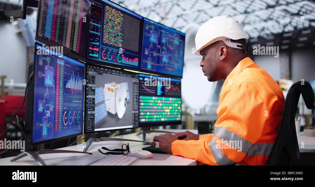 Young Engineer Designs Satellite Model Using 3D CAD Software On Computer. Stock Photo