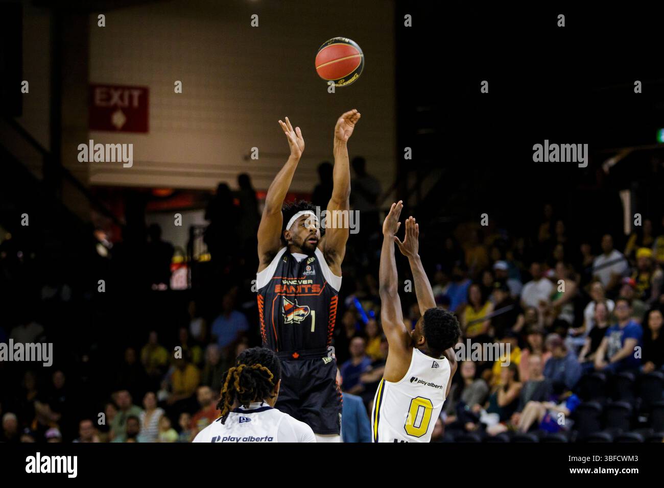 Vancouver's Izaiah Brockington (1) shoots for 3 points over Edmonton's Elijah Miller (0) during the game between Edmonton Stingers and Vancouver Bandits at Edmonton Expo Centre. Final scores; Edmonton Stingers 95-104 Vancouver Bandits. (Photo by Ron Palmer / SOPA Images/Sipa USA) Stock Photo