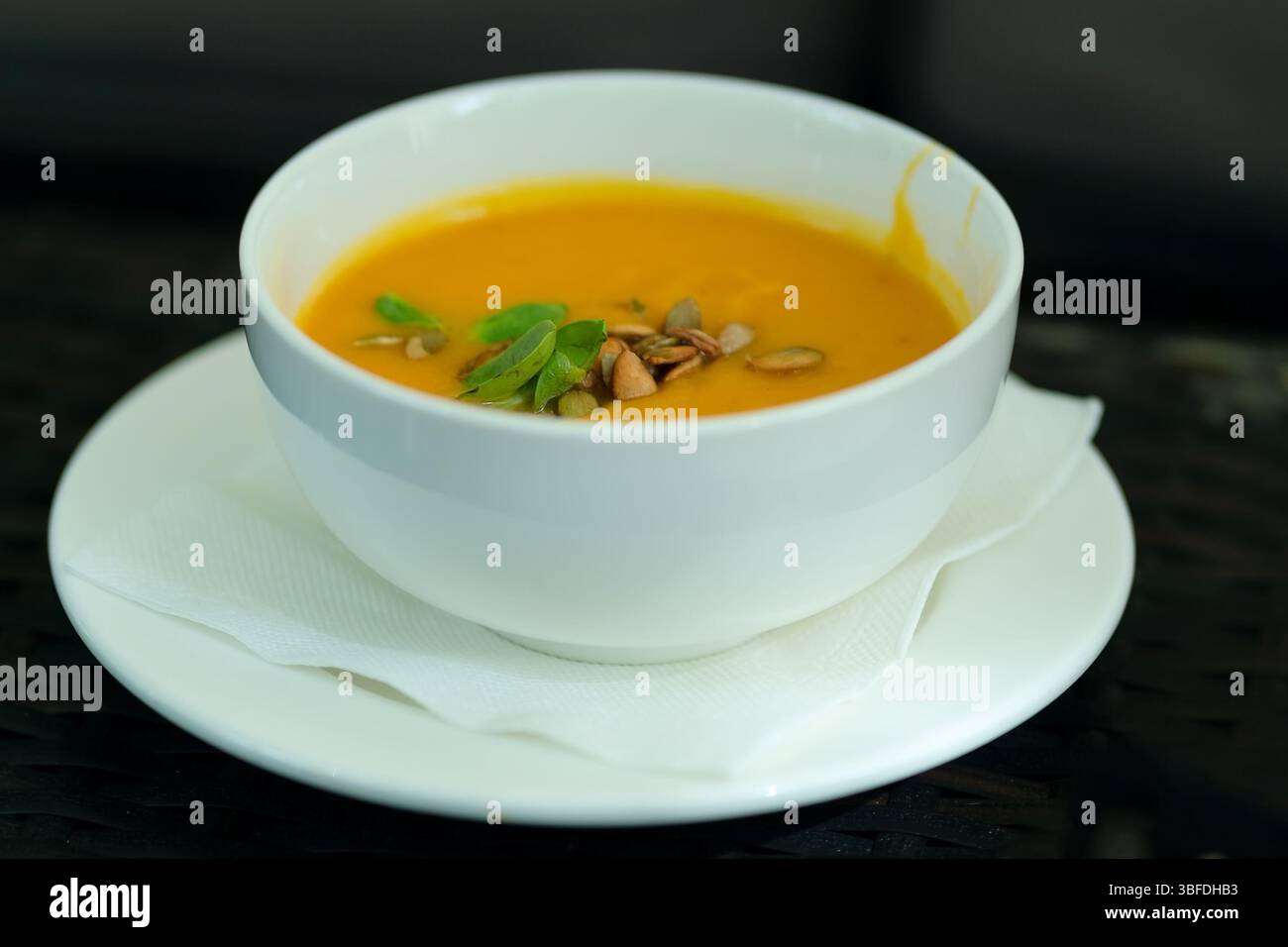 Nutrient-packed pumpkin puree soup with toasted seeds topping. Restaurant-quality vegetarian dish that's both delicious and wholesome. Stock Photo