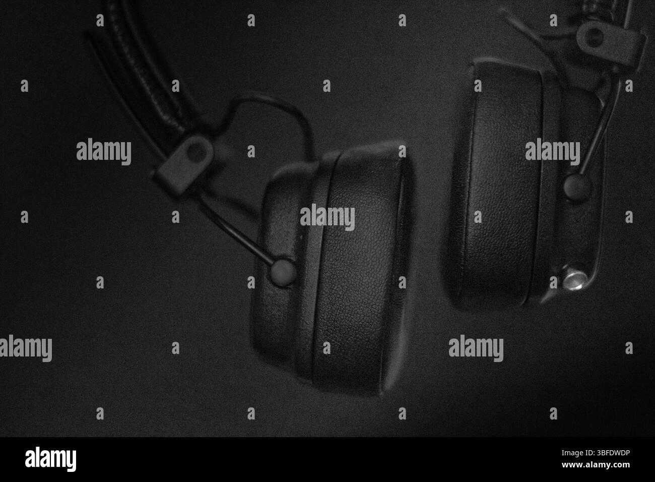 Black Headphones Captured in a Close-Up View Above a Dark Background Stock Photo